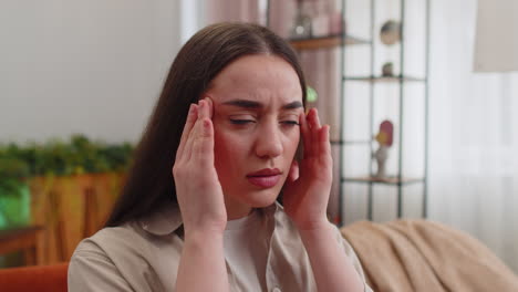 displeased young woman rubbing temples to cure headache problem suffering from migraine stress