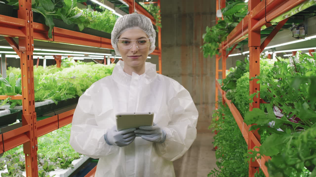 Portrait Of Female Greenhouse Worker At Vertical Farm