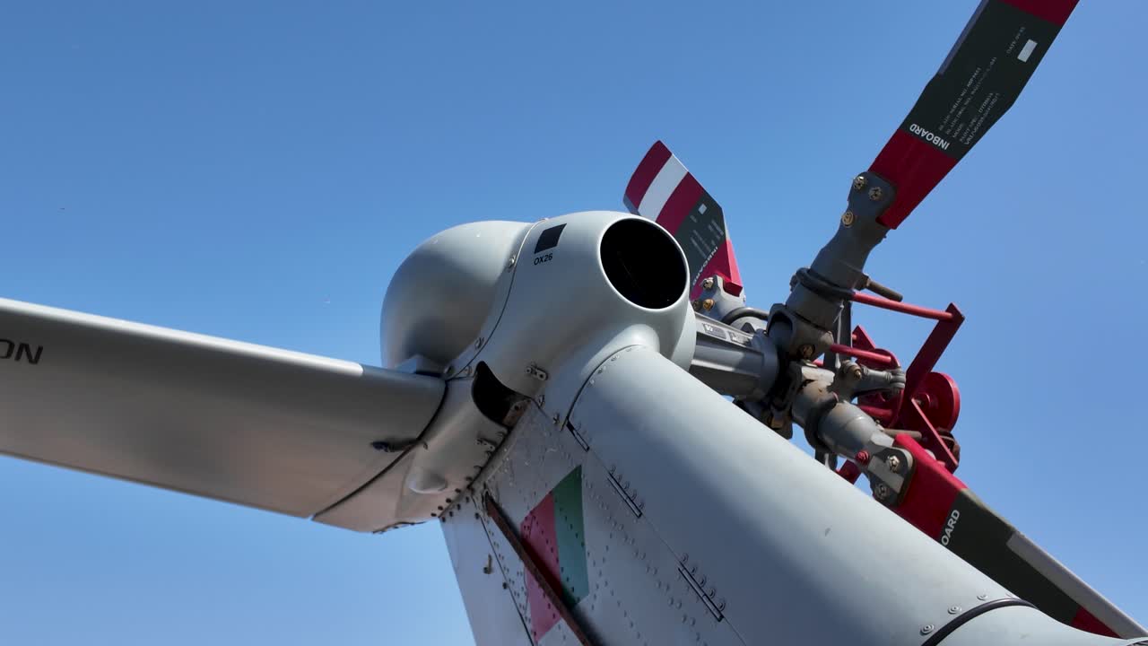 Focused shot of a modern helicopter's intricate tail rotor mechanisms under a clear sky