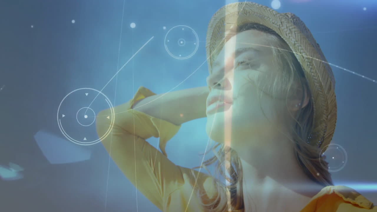 Wearing straw hat, woman in sunlight with digital animation overlay outdoors