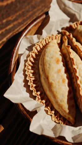 delicious empanadas on a wooden tray