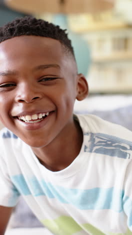 vertical video: smiling boy in striped shirt enjoying family lunch at home
