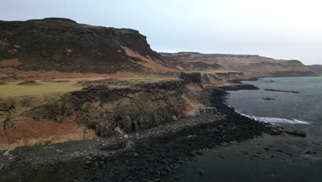 Linear-Establishing-Aerial-View-of-Rugged-Rocky-Coastline-Near-the-Ocean