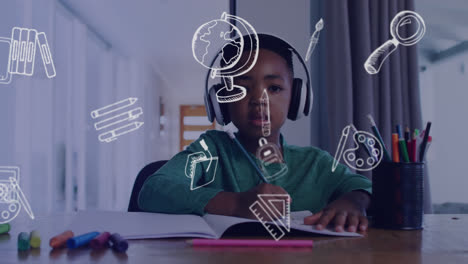 animation of school subject items over schoolboy in headphones writing during online lesson