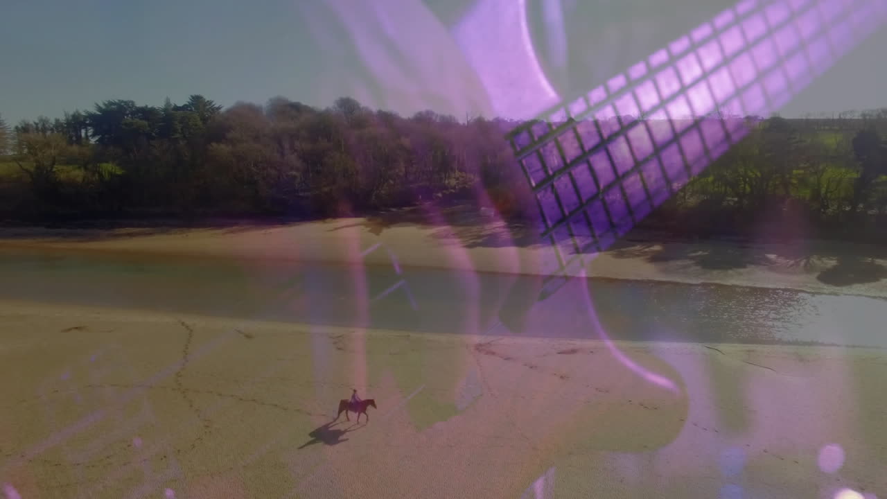 male rider traveling sandy beach, with purple grid and hand shapes representing technology