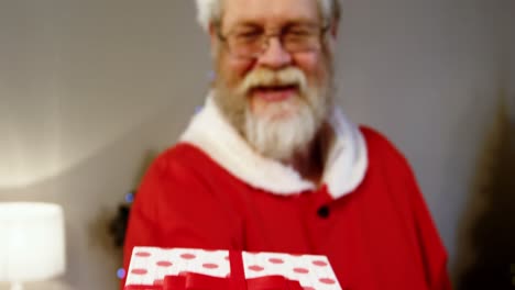 portrait of santa claus holding gift box