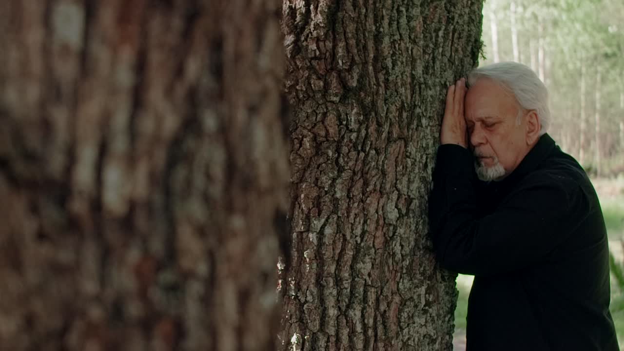 Elderly Man by a Tree
