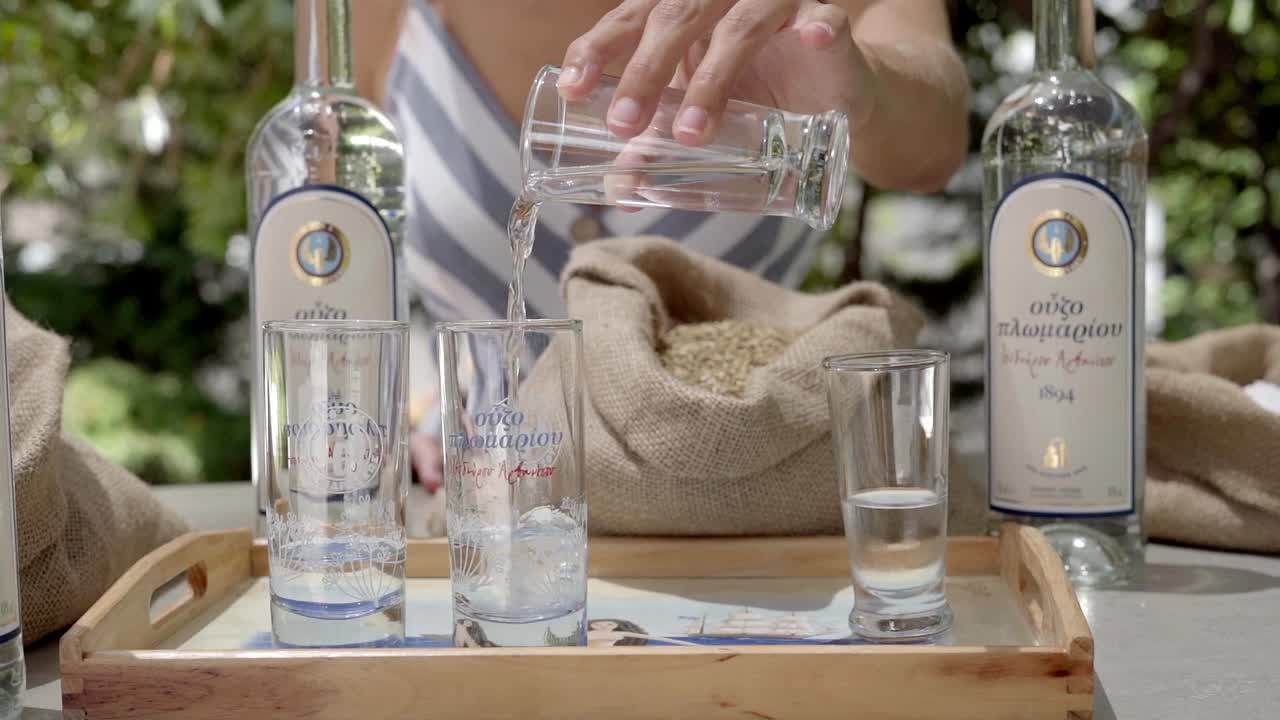 Greek traditional drink Ouzo raki water mixing process for tasting at The World of Ouzo museum in Slow motion