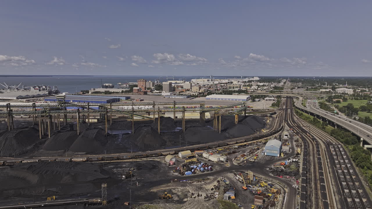 Newport News Virginia Aerial v4 flyover Dunbar Coal Transfer facility featuring black coal mounds and conveyor infrastructure support global energy export - Shot with Mavic 3 Pro Cine - Sept 30th 2023