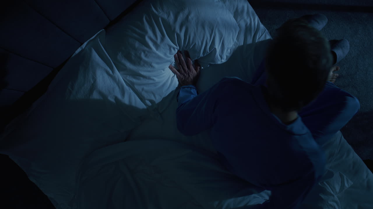 Mature Man Lies in Bed Staring Into Darkness with Deep Existential Thoughts