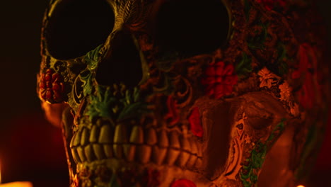 close up on still life of decorated skulls lit by candles celebrating mexican holiday of dia de muertos or day of the dead 5