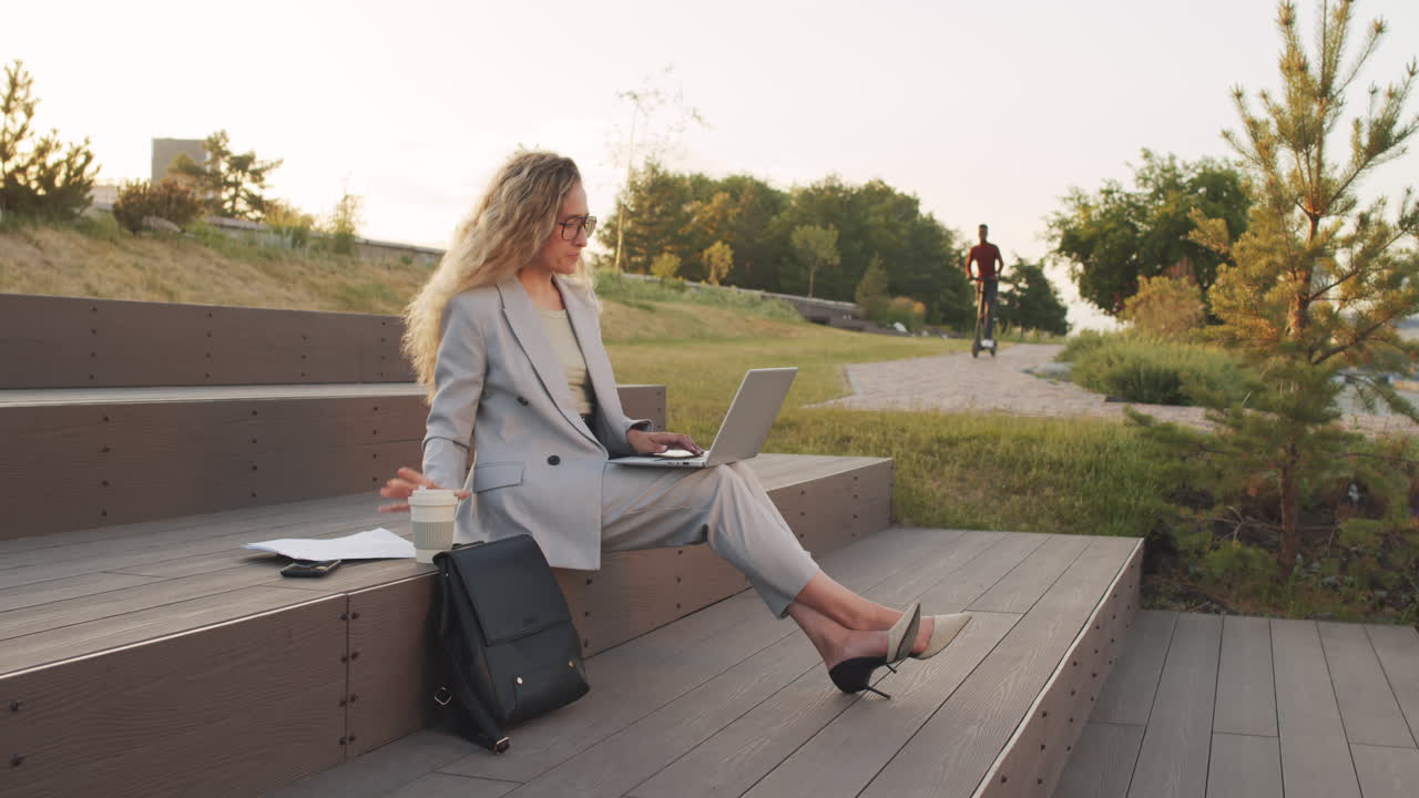 Business Woman Working on Laptop Outdoors