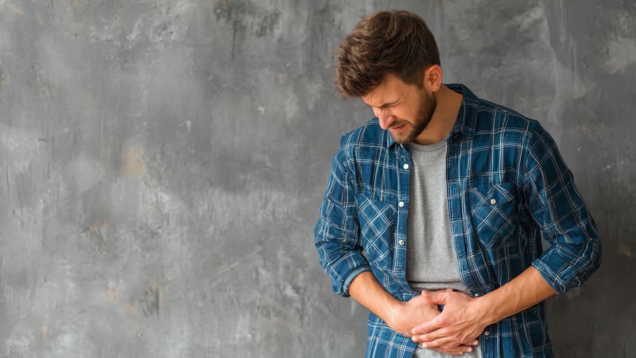 Man Holding Stomach in Discomfort Expresses Pain and Distress in Emotional Moment; Captured in Two Frames Showcasing the Severity of His Suffering