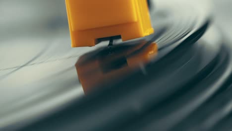 vinyl player turntable. a fragment of a rotating vinyl record, a stylus with a needle close-up. stopping a needle and a vinyl plate close-up. macro