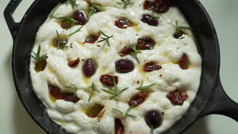 italian focaccia being made in a cast iron pan