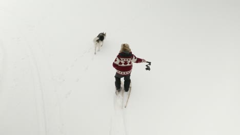 Adult-man-in-large-fur-hat-films-himself-walking-in-snow-shoes-with-a-DJI-Ronin-RSC-2-gimbal