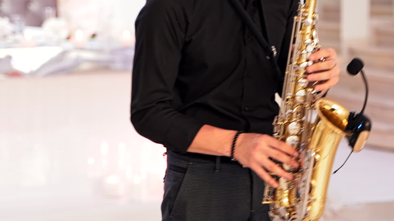 Saxophonist hands playing on saxophone. Professional saxophonist playing on sax at concert stage