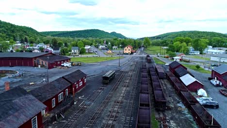 An-Aerial-View-of-an-Abandoned-Narrow-Gauge-Coal-Rail-Road-with-Rusting-Hoppers-and-Freight-Cars-and-Support-Building-Starting-to-be-Restored