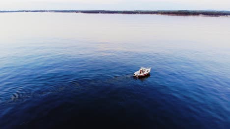 aerial: little fishing boat goes back to land