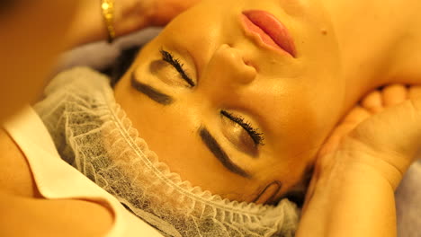 beautiful girl getting neck massage in beauty salon