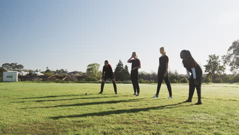 playing cricket outdoors, women in sportswear enjoying sunny day together