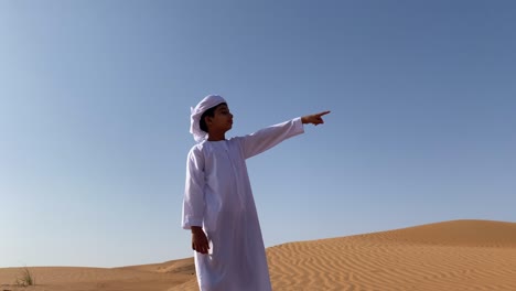 emarati child pointing something looking long