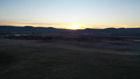 sunset over a rural farm gate