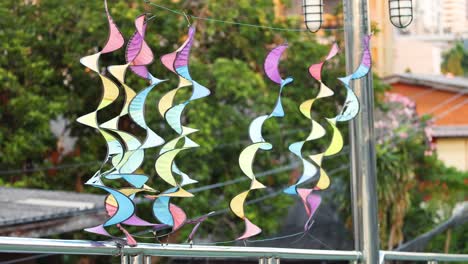 a vibrant ribbon spinner rotates in the breeze.