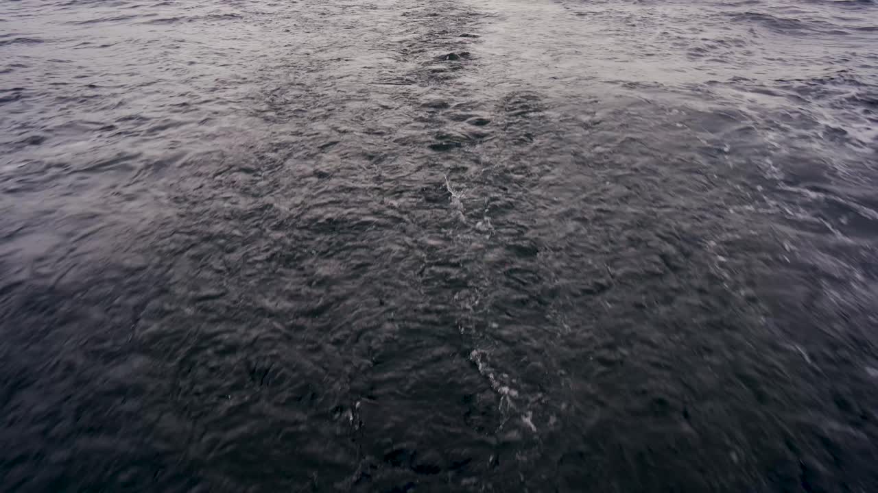Dark moody water seascape trailing behind the camera, close up