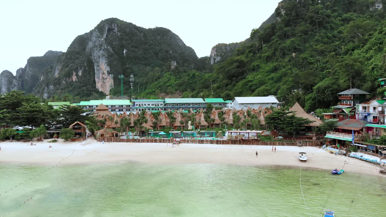 Green lush mountains by seaside tropical resort, Phuket, Thailand, aerial