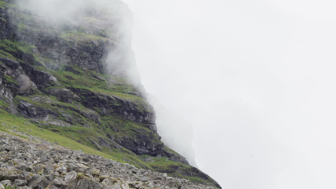nubes y niebla moviéndose en el acantilado rocoso de la isla de lovund en noruega