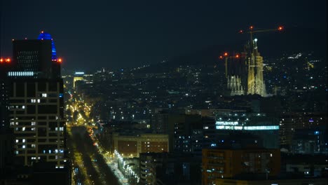 Night-Timelapse-of-Barcelona-featuring-the-popular-church,-La-Sagrada-Familia,-and-traffic-over-the-Diagonal-Avenue