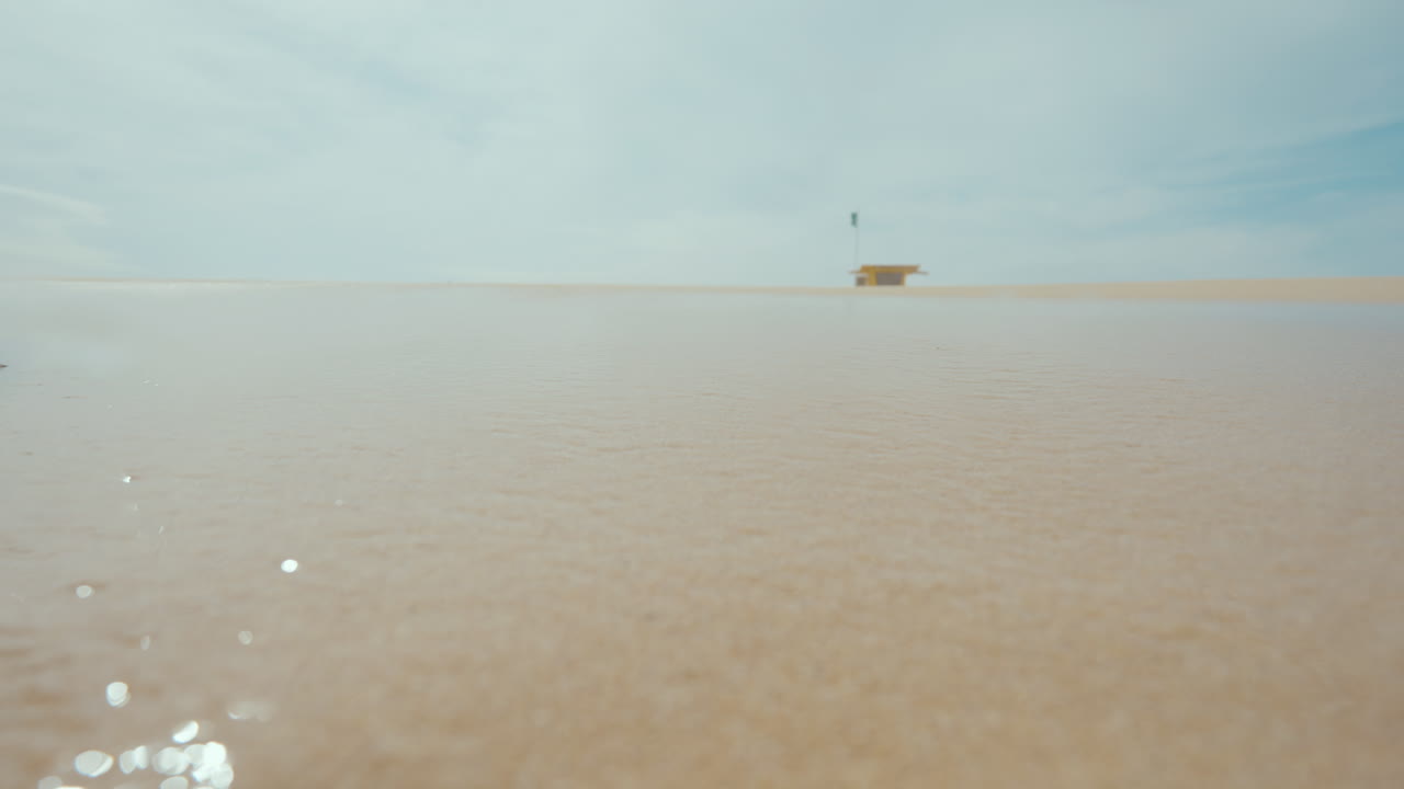 Person walking or running on the wet sand of a beach