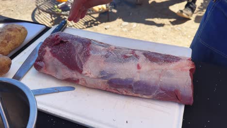 chef salting meat for the grill argentine style