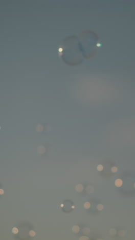 close-up of bubbles floating in the air against a clear sky. the bubbles reflect light, creating a dreamy, whimsical scene of a simple joy and beauty of bubbles drifting freely in the open air