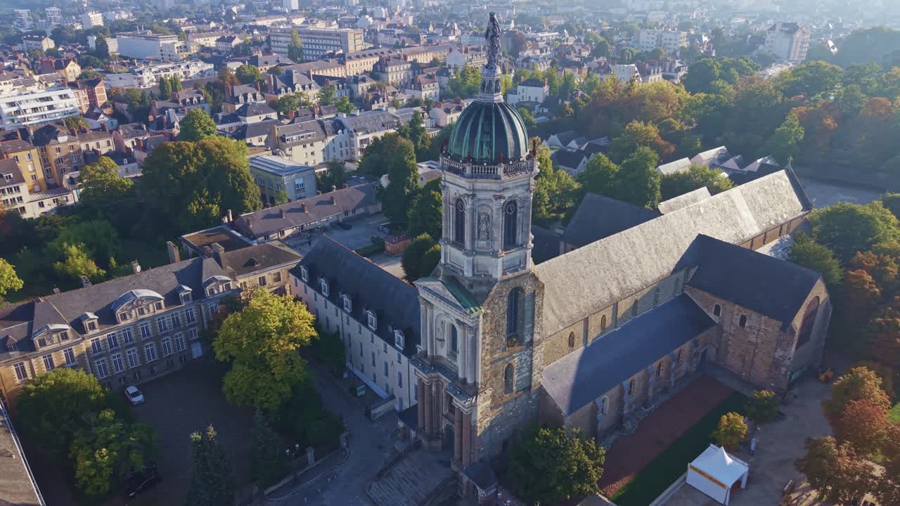 Drone pullback then arc around Saint-Melaine Church in Rennes at sunrise