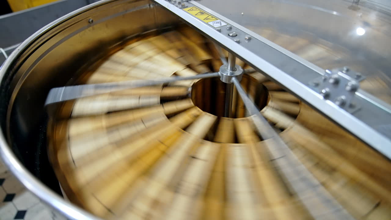 Getting honey from honeycomb. Manual centrifuge device, spinning the honey from cells
