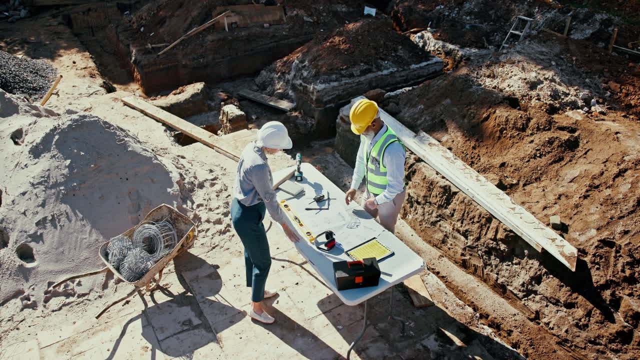 Construction site inspection with building plans