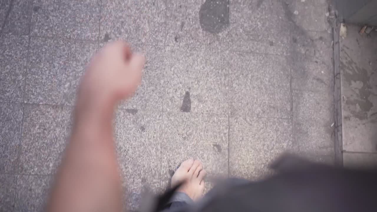 Person Walking Barefoot on a City Street