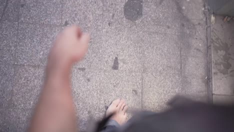 person walking barefoot on a city street