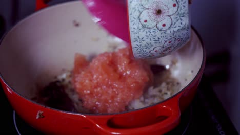 adding tomatoes to a curry dish green and ripe yellow organic fresh papaya pawpaw