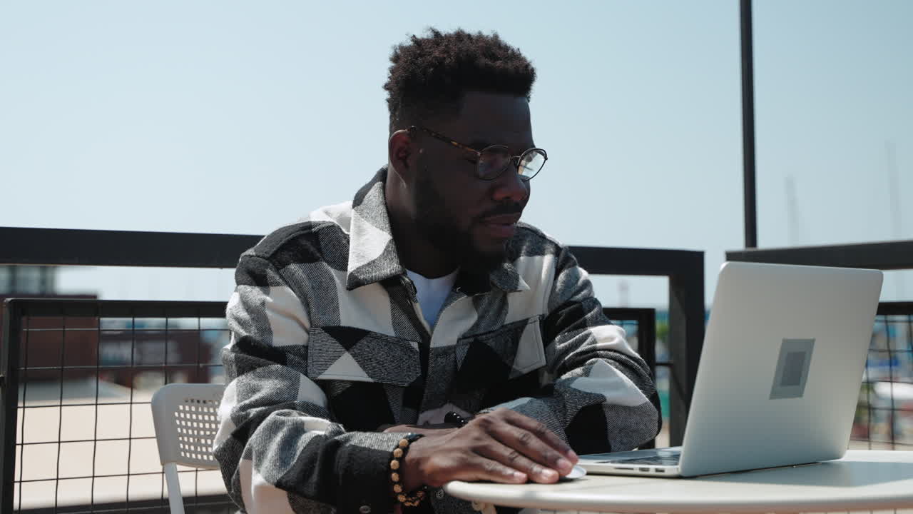 Man working on laptop outdoors