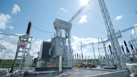 high voltage transformer against the blue sky. electric current redistribution substation