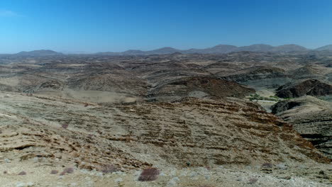 Aerial flying over a Natonal park in Nambia with rough terrain.