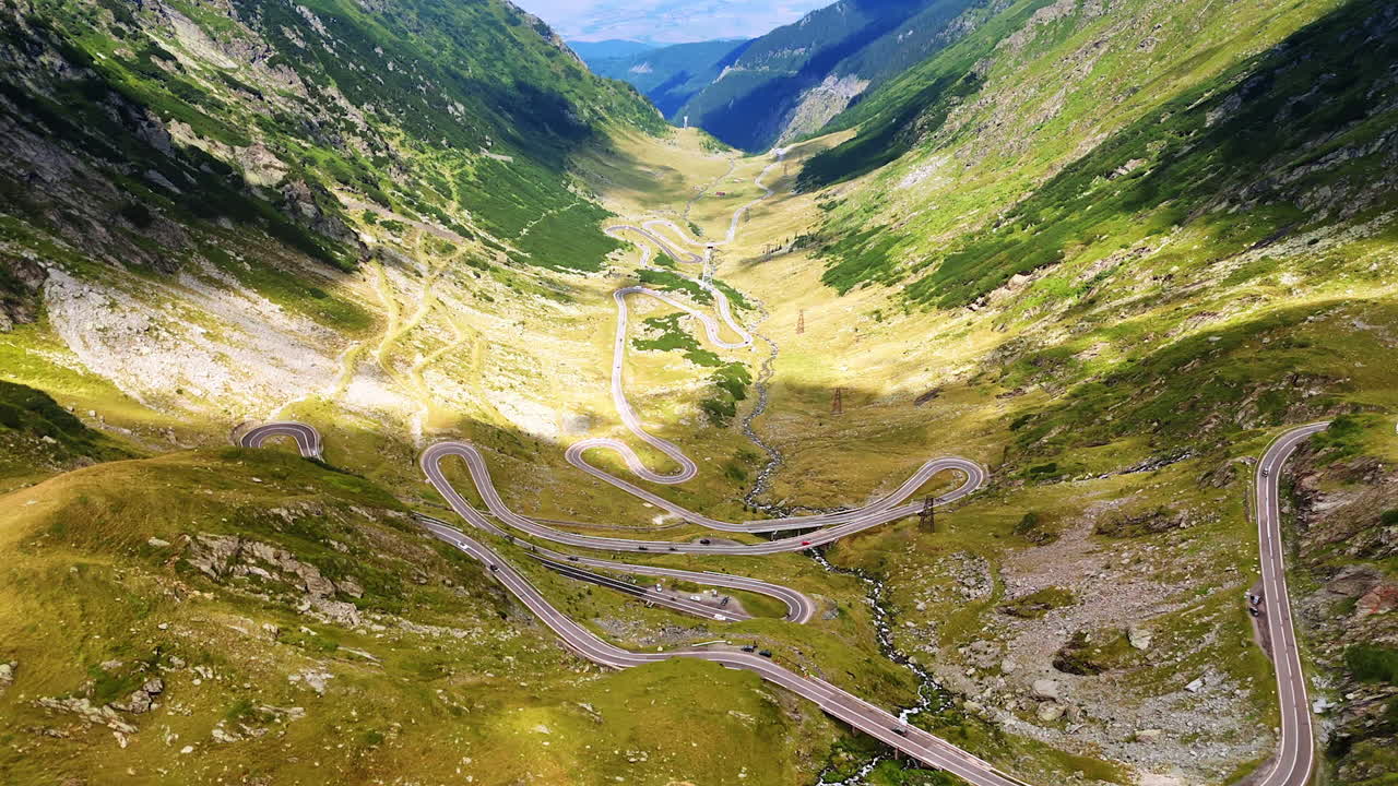 Wriggly Transfagarash highway in the beautiful valley. Drone flight over the famous road among the Carpathian Mountains in Romania