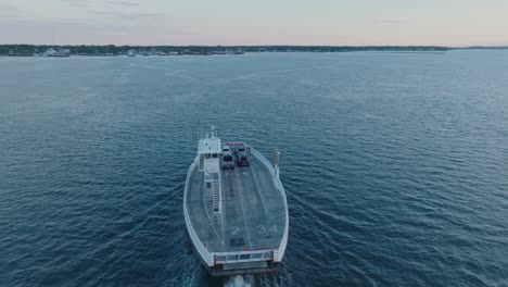 top down aerial drone shot of ferry departing shelter island heading towards greenport north fork long island new york before sunrise