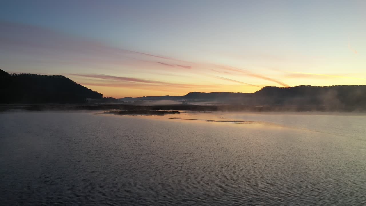 안개 가 가득 한 습지 강 위 에서 해가 뜨는 것