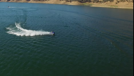 a nice summer day out on the lake enjoying some watersports with boats and personal watercraft