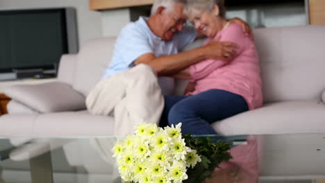 Senior-couple-cuddling-on-the-couch