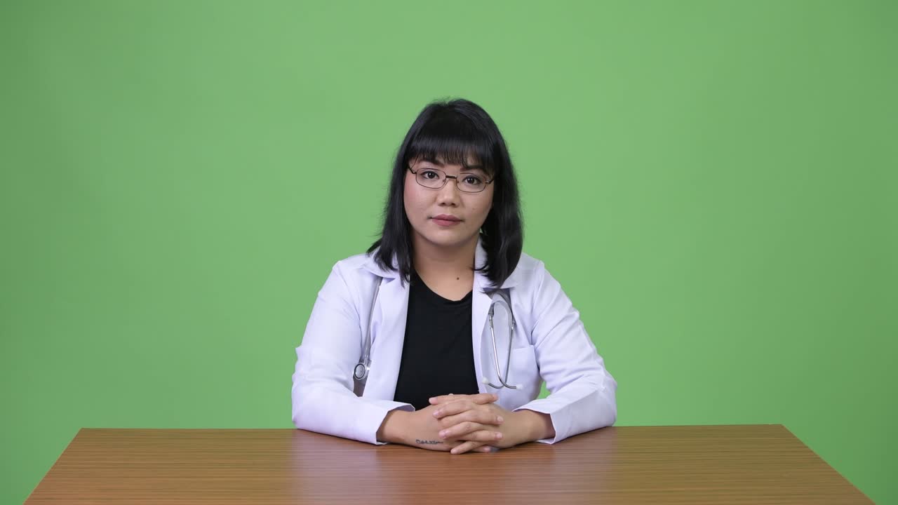 Beautiful Asian woman doctor smiling and greeting